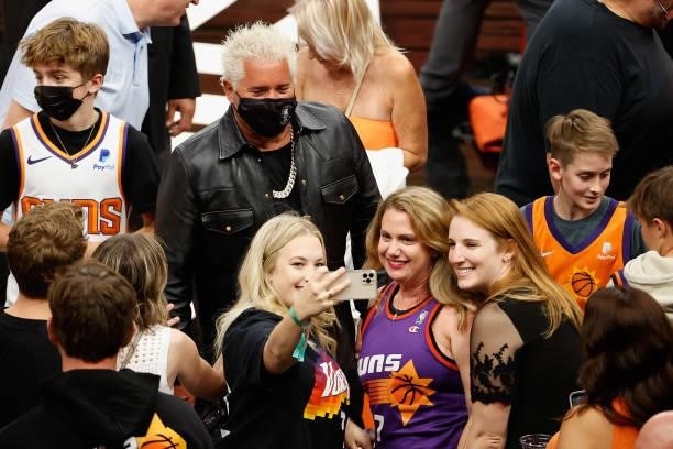Television personality Guy Fieri poses with fans following Game One of the Western Conference second-round playoff series between the Phoenix Suns...