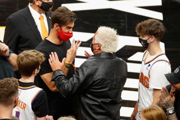 Olympic swimmer Michael Phelps talks with television personality Guy Fieri following Game One of the Western Conference second-round playoff series...