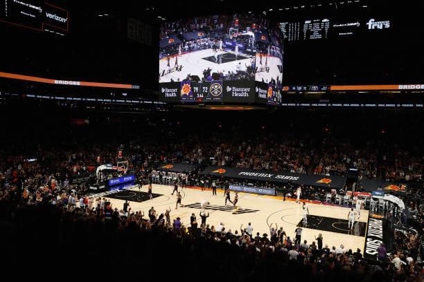 Fans cheer after Devin Booker of the Phoenix Suns made a three-point shot against the Denver Nuggets during the second half in Game One of the...