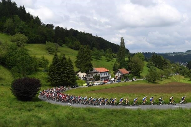 Stefan Küng of Switzerland and Team Groupama - FDJ Yellow Leader Jersey & The Peloton passing through Oberkulm during the 84th Tour de Suisse 2021,...
