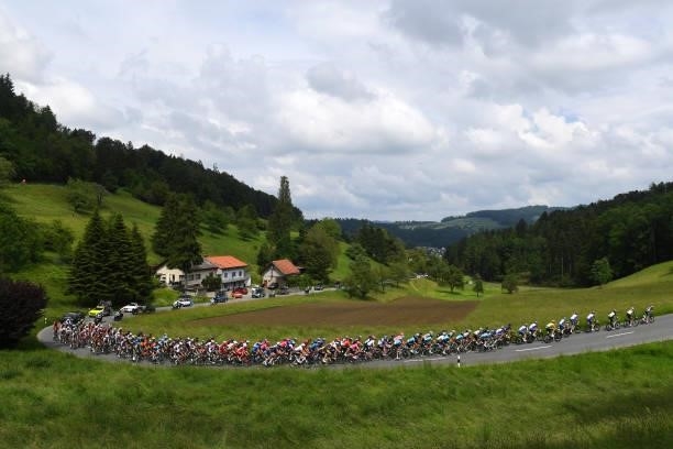 Stefan Küng of Switzerland and Team Groupama - FDJ Yellow Leader Jersey & The Peloton passing through Oberkulm during the 84th Tour de Suisse 2021,...