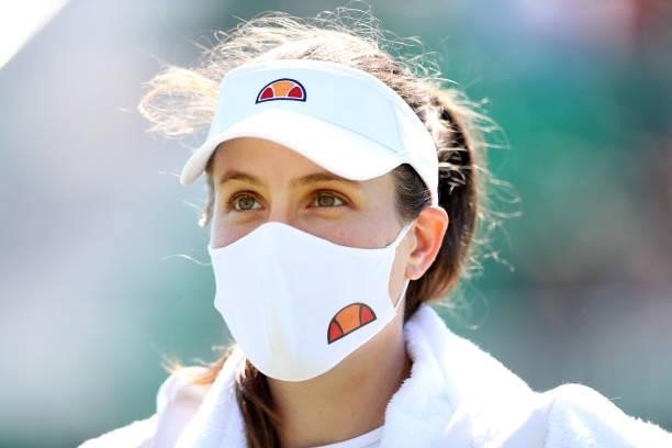 Johanna Konta of Great Britain wears a face mask as she looks on after victory against Lesley Pattinama Kerkhove of the Netherlands during Day 4 of...