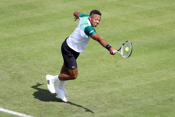 Jay Clarke of Great Britain plays a backhand against Kevin Anderson of South Africa during Day 4 of the Viking Nottingham Open at Nottingham Tennis...