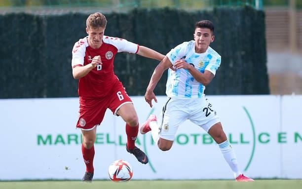 Rasmus Cartensen of Denmark U21 competes for the ball with Thiago Almada of Argentina U23 during a Friendly International Match between Denmark and...