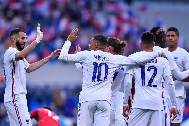 Antoine Griezmann of France is congratulated by Kylian Mbappe and Karim Benzama after scoring during the international friendly match between France...