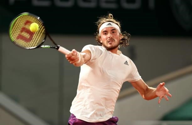 Stefanos Tsitsipas of Greece plays a forehand in their mens singles quarter final match against Daniil Medvedev of Russia during day ten of the 2021...