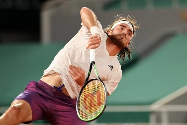 Stefanos Tsitsipas of Greece serves in their mens singles quarter final match against Daniil Medvedev of Russia during day ten of the 2021 French...