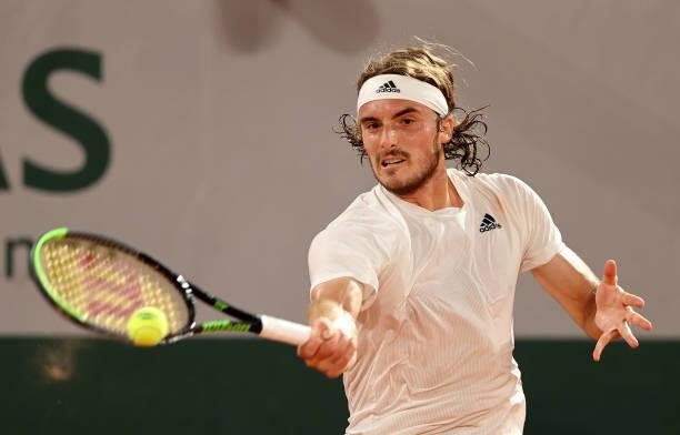 Stefanos Tsitsipas of Greece plays a forehand in their mens singles quarter final match against Daniil Medvedev of Russia during day ten of the 2021...