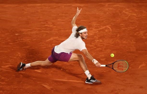 Stefanos Tsitsipas of Greece plays a backhand in their mens singles quarter final match against Daniil Medvedev of Russia during day ten of the 2021...
