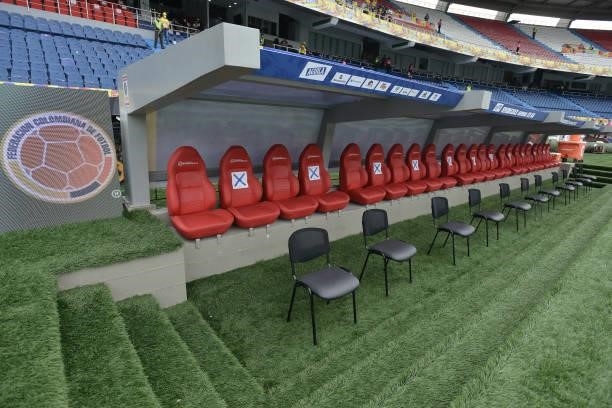 Extra seats are placed next to the substitutes bench to guarantee social distance as a preventive measure against COVID-19 during a match between...