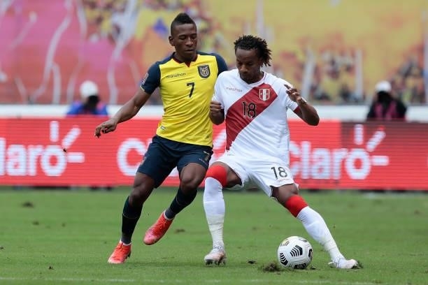 André Carrillo of Peru fights for the ball with Pervis Estupiñan of Ecuador during a match between Ecuador and Peru as part of South American...