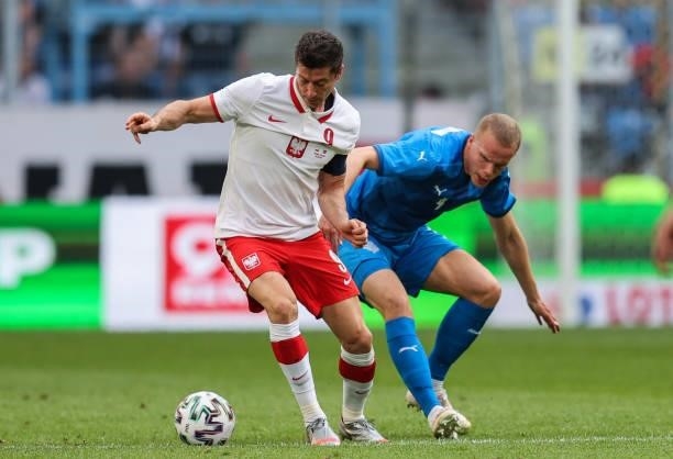 Robert Lewandowski of Poland is challenged by Hjortur Hermannsson of Iceland during the international friendly match between Poland and Iceland at...