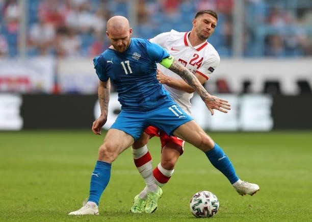 Albert Gudmundsson of Iceland is challenged by Jakub Swierczok of Poland during the international friendly match between Poland and Iceland at...