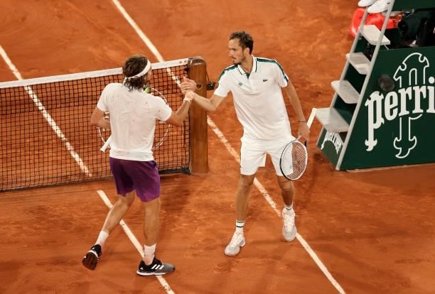 Stefanos Tsitsipas of Greece is congratulated by Daniil Medvedev of Russia after their mens singles quarter final match during day ten of the 2021...