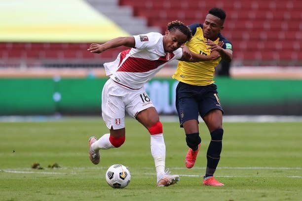 André Carrillo of Peru fights for the ball with Pedro Perlaza of Ecuador during a match between Ecuador and Peru as part of South American Qualifiers...