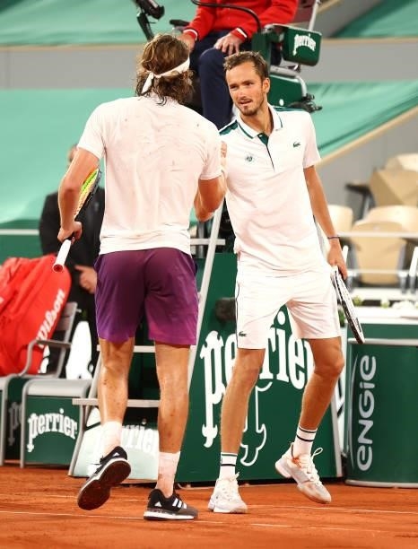 Stefanos Tsitsipas of Greece is congratulated by Daniil Medvedev of Russia after their mens singles quarter final match during day ten of the 2021...