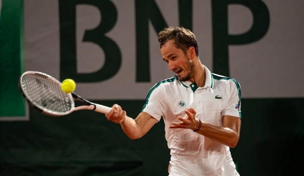 Daniil Medvedev of Russia hits a forehand against Stefanos Tsitsipas of Greece in the quarterfinals of the men's singles at Roland Garros on June 08,...