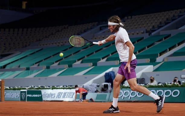 Stefanos Tsitsipas of Greece plays a backhand shot in his Quarter Final match against Daniil Medvedev of Russia during day ten of the 2021 French...