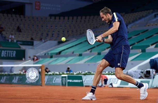 Daniil Medvedev of Russia plays a backhand shot in his Quarter Final match against Stefanos Tsitsipas of Greece during day ten of the 2021 French...