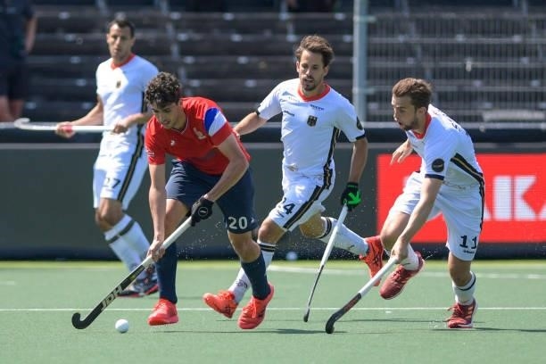 Eliot Curty of France battles for possession with Constantin Staib of Germany and Benedikt Furk of Germany during the Euro Hockey Championships match...