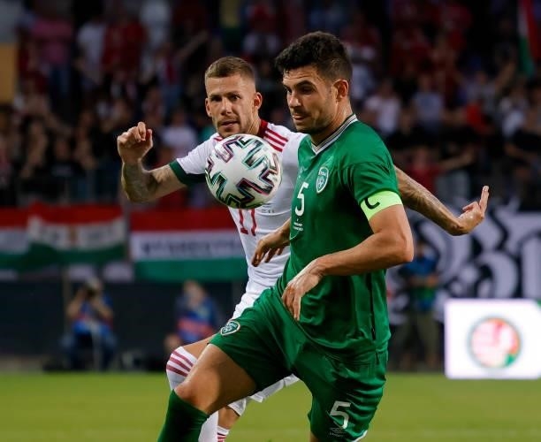 John Egan of Republic of Ireland competes for the ball with Roland Varga of Hungary during the International Friendly match between Hungary and...