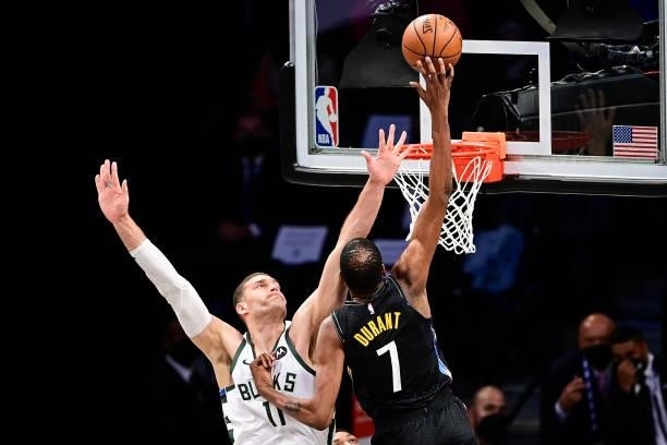 Kevin Durant of the Brooklyn Nets attempts a shot against Brook Lopez of the Milwaukee Bucks in Game Two of the Second Round of the 2021 NBA Playoffs...