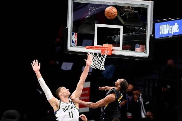 Kevin Durant of the Brooklyn Nets attempts a shot against Brook Lopez of the Milwaukee Bucks in Game Two of the Second Round of the 2021 NBA Playoffs...