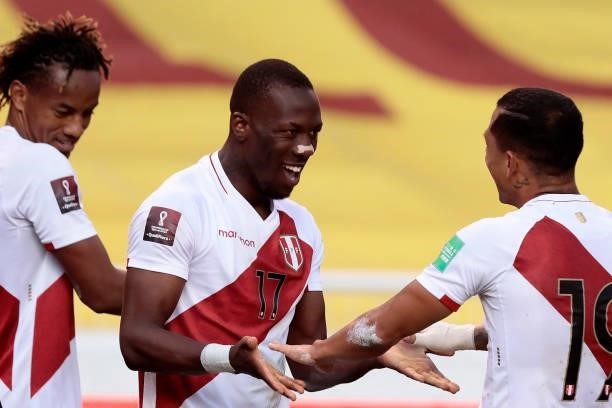 Luis Advíncula of Peru celebrates after scoring the second goal of his team with Yoshimar Yotún of Peru during a match between Ecuador and Peru as...