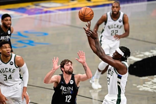Joe Harris of the Brooklyn Nets defends a shot against Jrue Holiday of the Milwaukee Bucks in Game Two of the Second Round of the 2021 NBA Playoffs...