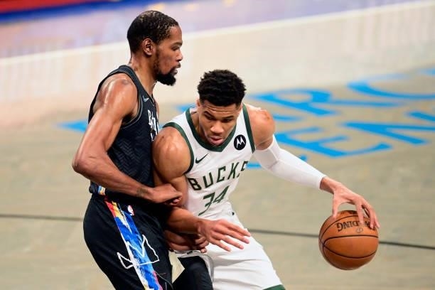 Giannis Antetokounmpo of the Milwaukee Bucks is defended by Kevin Durant of the Brooklyn Nets in Game Two of the Second Round of the 2021 NBA...