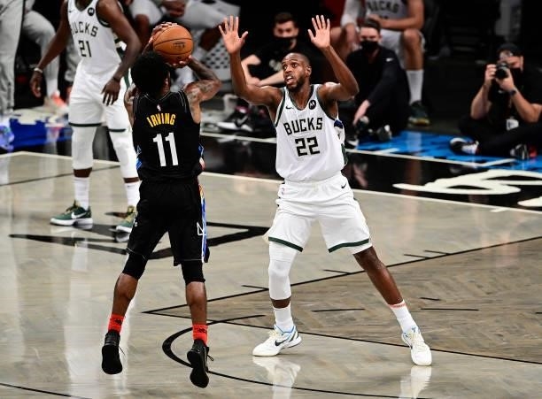 Kyrie Irving of the Brooklyn Nets attempts a shot against Khris Middleton of the Milwaukee Bucks in Game Two of the Second Round of the 2021 NBA...