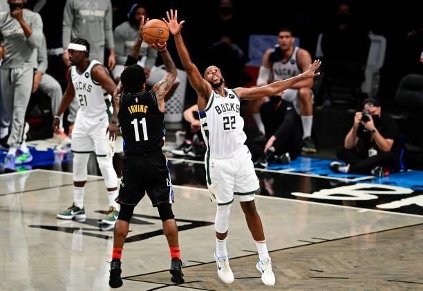 Kyrie Irving of the Brooklyn Nets attempts a shot against Khris Middleton of the Milwaukee Bucks in Game Two of the Second Round of the 2021 NBA...