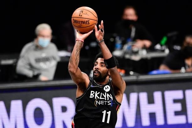 Kyrie Irving of the Brooklyn Nets attempts a jump shot against the Milwaukee Bucks in Game Two of the Second Round of the 2021 NBA Playoffs at...