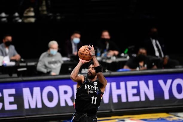 Kyrie Irving of the Brooklyn Nets attempts a jump shot against the Milwaukee Bucks in Game Two of the Second Round of the 2021 NBA Playoffs at...