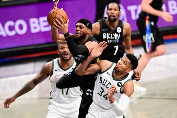 Bruce Brown of the Brooklyn Nets grabs a rebound against Giannis Antetokounmpo of the Milwaukee Bucks in Game Two of the Second Round of the 2021 NBA...