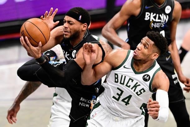 Bruce Brown of the Brooklyn Nets grabs a rebound against Giannis Antetokounmpo of the Milwaukee Bucks in Game Two of the Second Round of the 2021 NBA...
