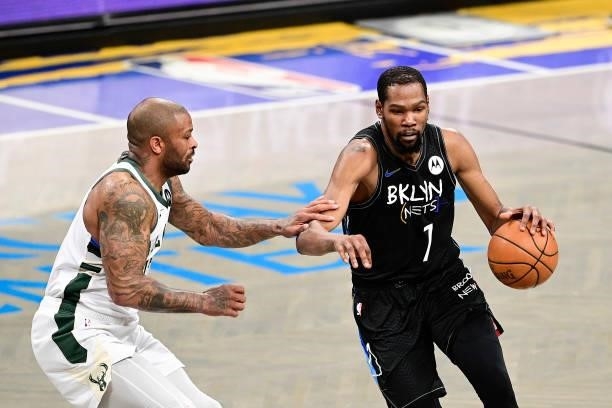 Kevin Durant of the Brooklyn Nets is defended by P.J. Tucker of the Milwaukee Bucks in Game Two of the Second Round of the 2021 NBA Playoffs at...