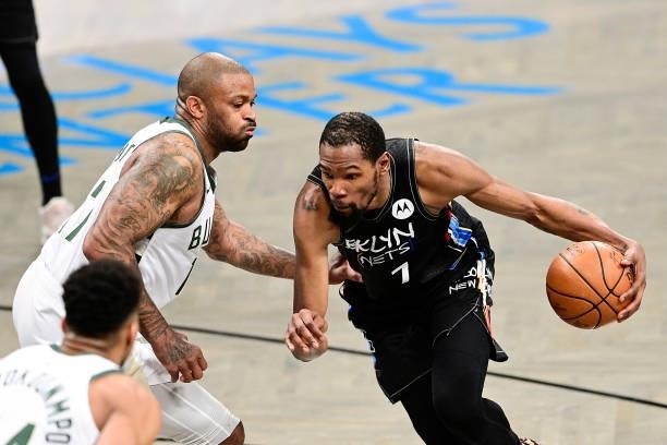 Kevin Durant of the Brooklyn Nets is defended by P.J. Tucker of the Milwaukee Bucks in Game Two of the Second Round of the 2021 NBA Playoffs at...
