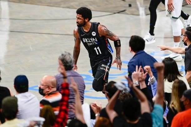 Kyrie Irving of the Brooklyn Nets celebrates after scoring a basket against the Milwaukee Bucks in Game Two of the Second Round of the 2021 NBA...