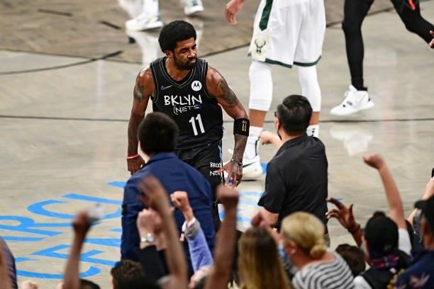 Kyrie Irving of the Brooklyn Nets celebrates after scoring a basket against the Milwaukee Bucks in Game Two of the Second Round of the 2021 NBA...