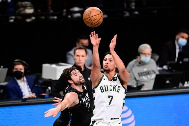 Bryn Forbes of the Milwaukee Bucks attempts a shot against Joe Harris of the Brooklyn Nets in Game Two of the Second Round of the 2021 NBA Playoffs...
