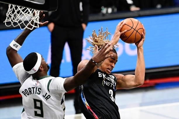 Nicolas Claxton of the Brooklyn Nets grabs a rebound against Bobby Portis of the Milwaukee Bucks in Game Two of the Second Round of the 2021 NBA...