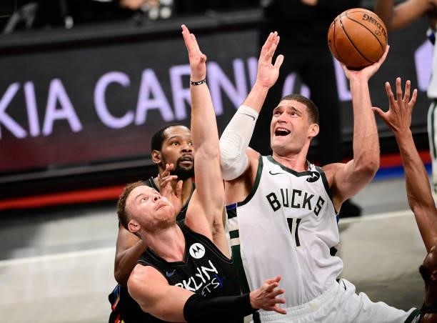 Brook Lopez of the Milwaukee Bucks attempts a shot against Blake Griffin of the Brooklyn Nets in Game Two of the Second Round of the 2021 NBA...
