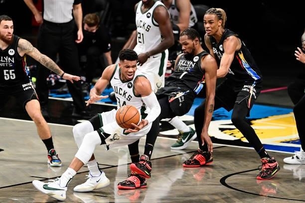 Giannis Antetokounmpo of the Milwaukee Bucks is fouled by Kevin Durant of the Brooklyn Nets in Game Two of the Second Round of the 2021 NBA Playoffs...