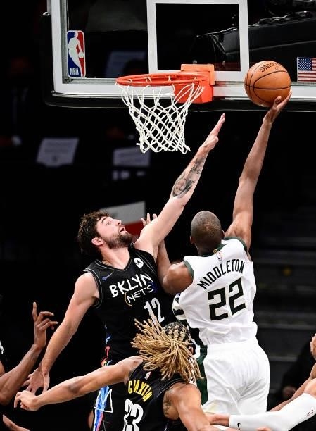 Joe Harris of the Brooklyn Nets defends a shot from Khris Middleton of the Milwaukee Bucks in Game Two of the Second Round of the 2021 NBA Playoffs...