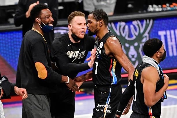 Kevin Durant of the Brooklyn Nets is congratulated by his teammates after scoring a basket against the Milwaukee Bucks in Game Two of the Second...