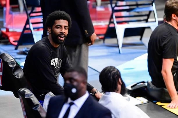 Kyrie Irving and James Harden of the Brooklyn Nets share a laugh on the bench against the Milwaukee Bucks in Game Two of the Second Round of the 2021...