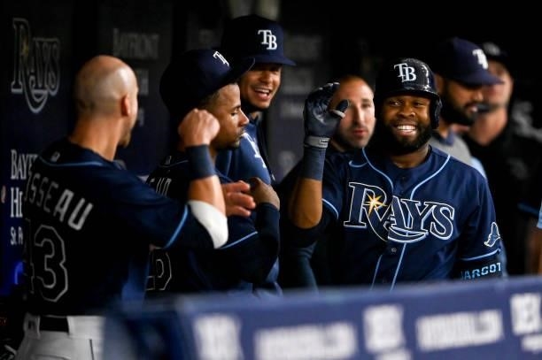 Manuel Margot of the Tampa Bay Rays celebrates with his teammates in the dugout after hitting a solo home run during the first inning against the...