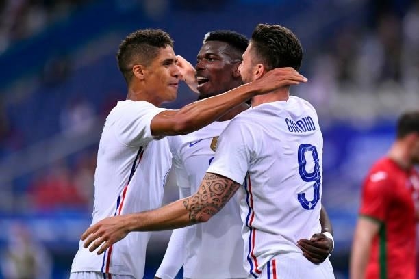 Olivier Giroud of France is congratulated by Paul Pogba and Raphael Varane after scoring during the international friendly match between France and...