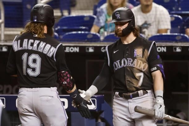 Charlie Blackmon of the Colorado Rockies celebrates with Brendan Rodgers after scoring a run during the fourth inning at loanDepot park on June 08,...